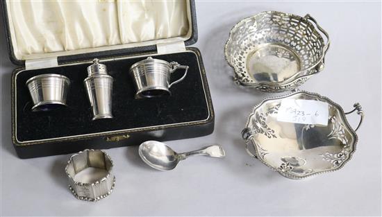 Two pierced silver sweetmeat dishes, a George III silver caddy spoon, silver three piece condiment set and silver napkin ring.